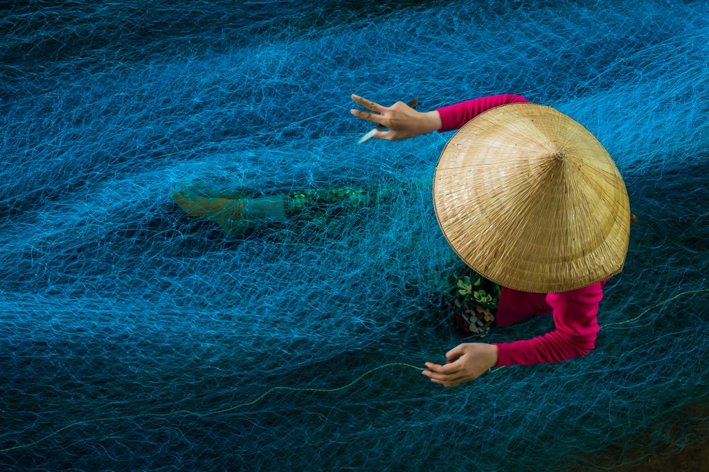 A lady is seen as she is busy in repairing the nets in a workshop situated in the outskirts of Bac Lieu, Vietnam