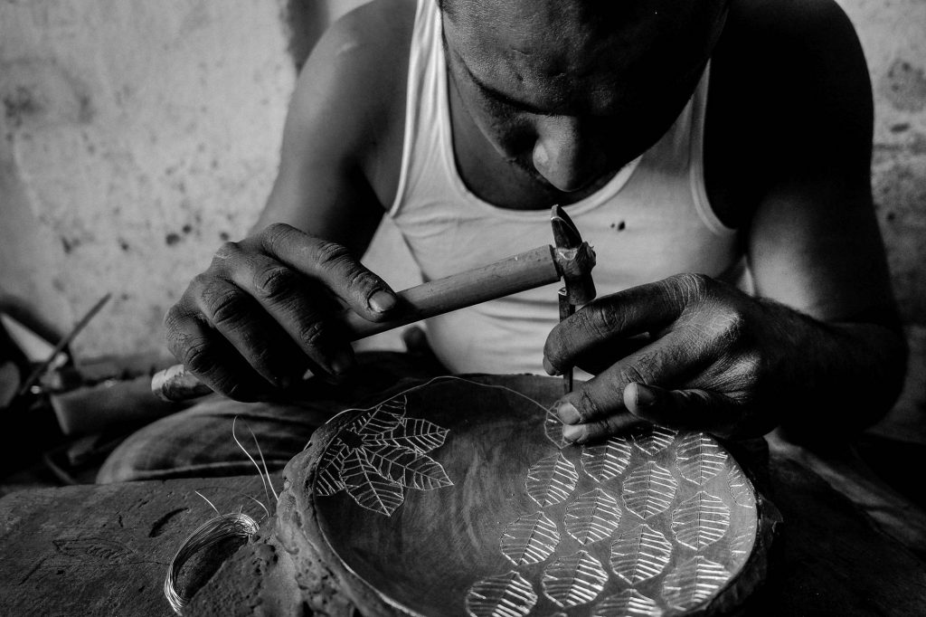 Meticulous and precision work for engraving the silver into the Bidriware