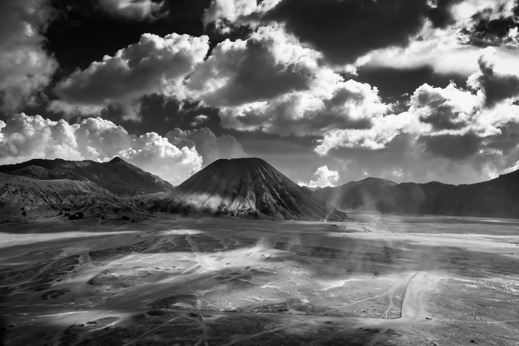 Surreal landscape of the Sea of Sands with Mt Batok (middle), and Mt Bromo (left)