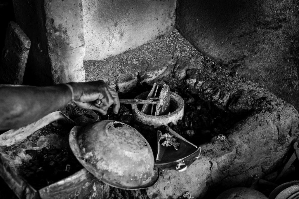 Worker pours the metals for melting