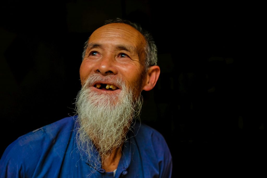 Huang Yue Ming - one of the oldest cormorant fishermen immersed in his deep thoughts as we speak with him at his house in Xingping village