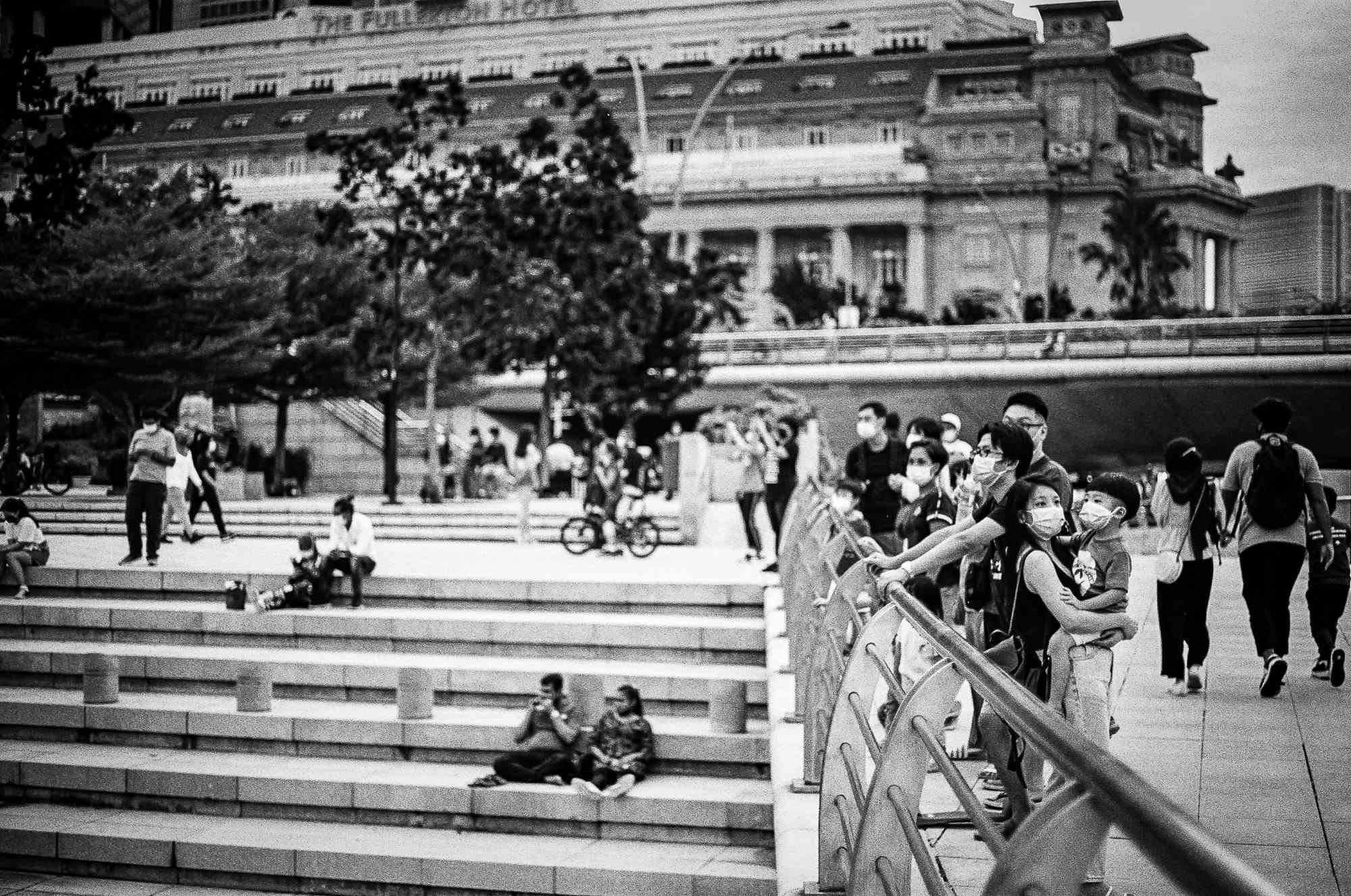 Couples and families are seen as they hang out in front of Merlion, Singapore