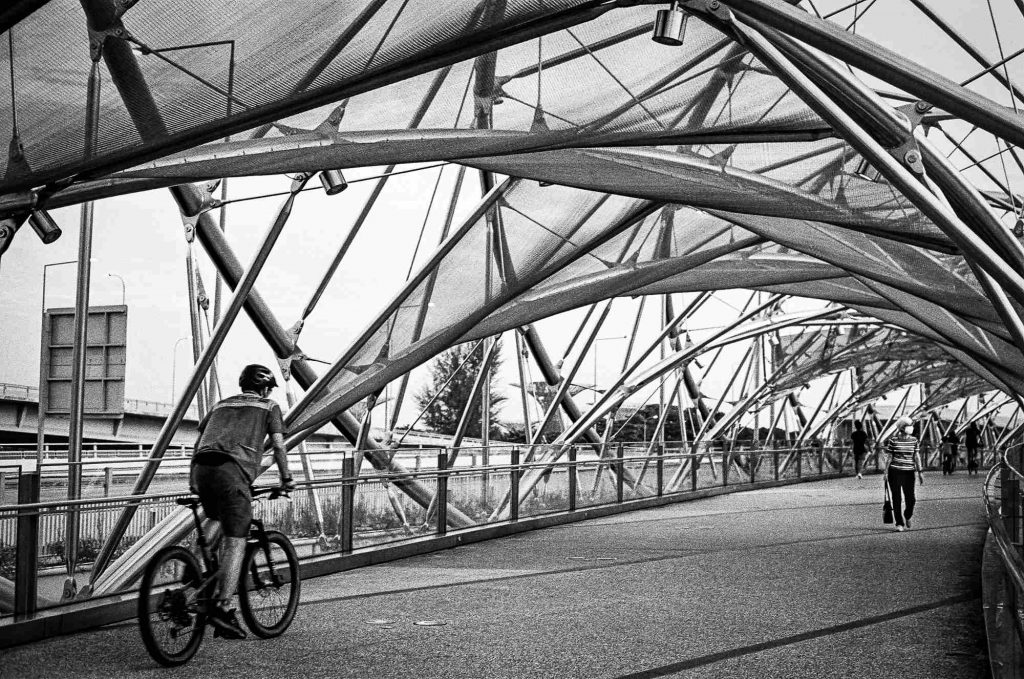 Walkers and cyclists are seen crossing the Helix Bridge in the Marina Bay area in Singapore.